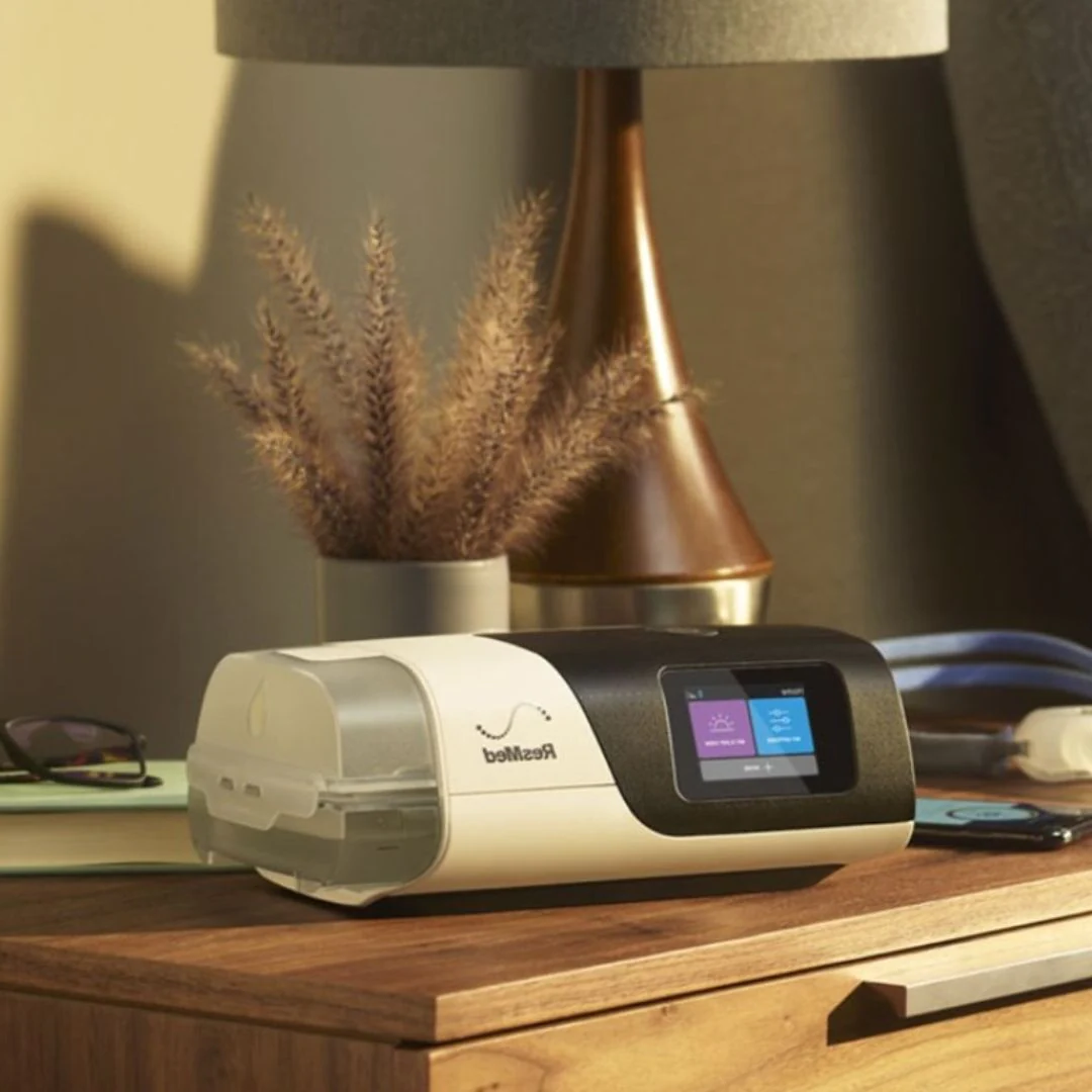 A ResMed CPAP machine on a night stand.